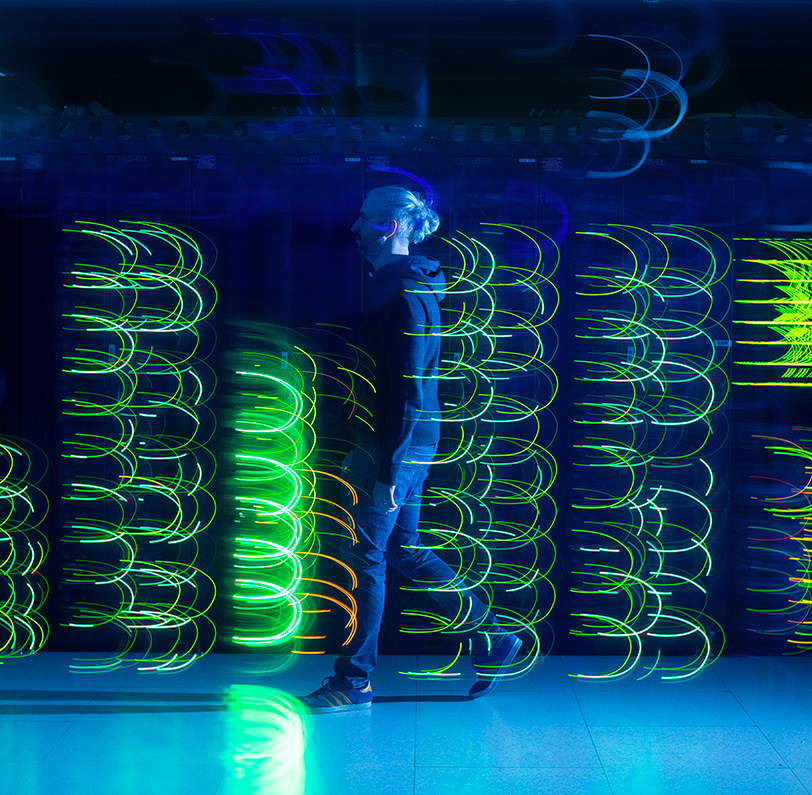 An Exaion engineer walking through an illuminated data centre